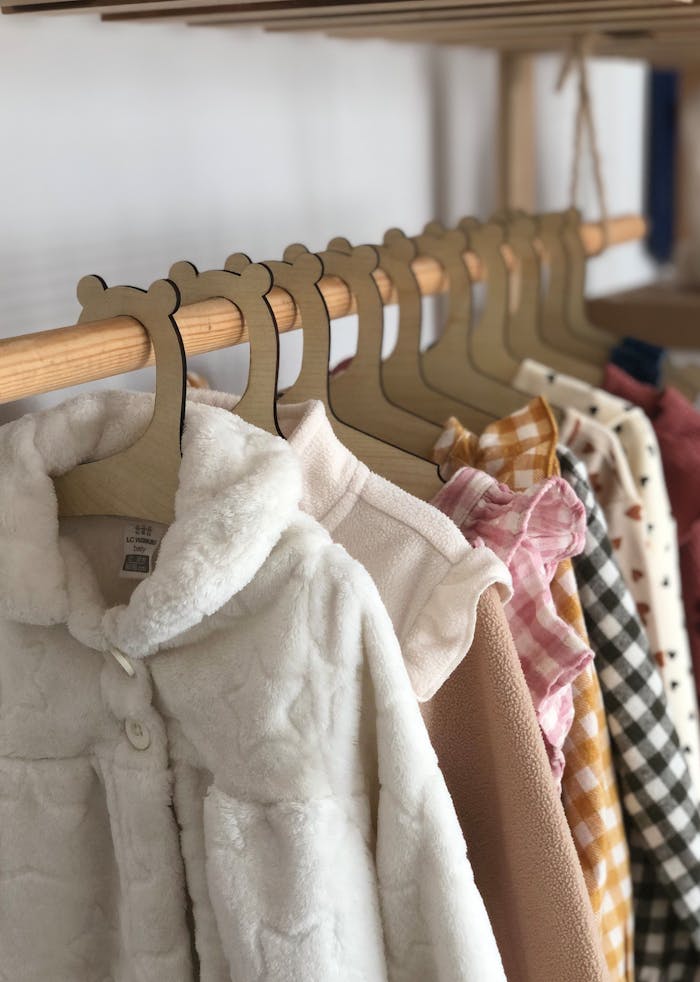 Crafting Captivating Headlines: Your awesome post title goes here Cozy childrens clothing neatly arranged on bear-themed hangers.